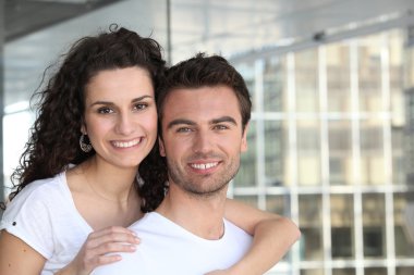 Couple all smiles near building clipart