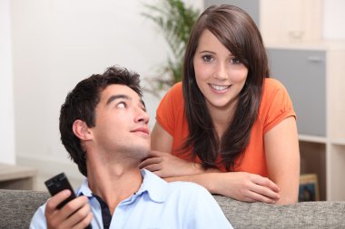 Young couple watching television clipart