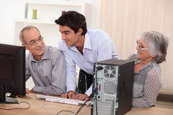 Elderly couple in front of a computer — Stock Photo, Image