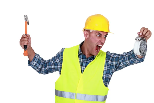 Angry tradesman looking at the time — Stock Photo, Image