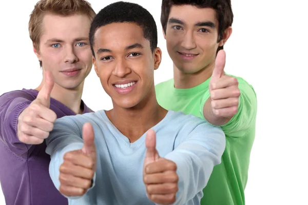 Three male friends giving thumbs-up — Stock Photo, Image