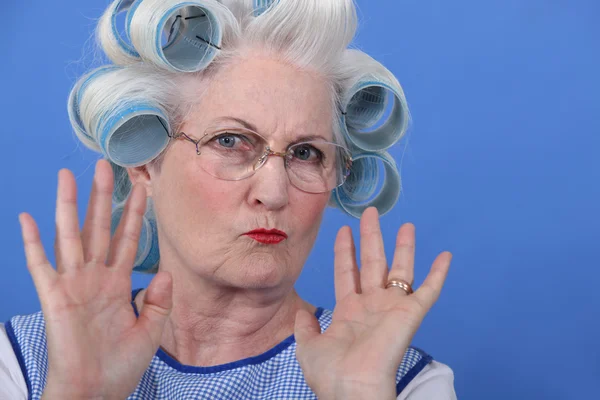 Old lady wearing hair rollers Royalty Free Stock Photos. 