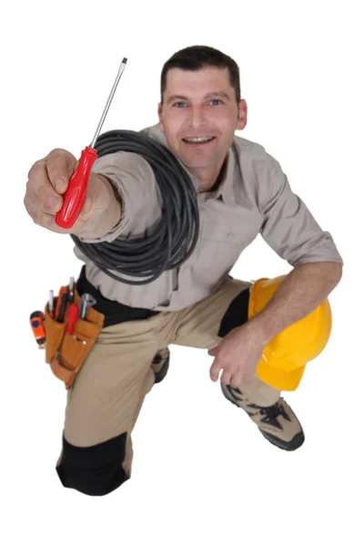 Electrician offering screwdriver — Stock Photo, Image