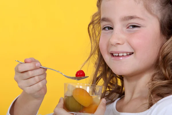 Girl with a glass of fruit salad — Stock Photo, Image