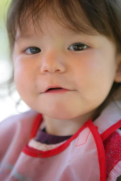 Little girl wearing a bib — Stock Photo, Image