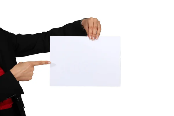 Hand pointing at white sheet of paper — Stock Photo, Image