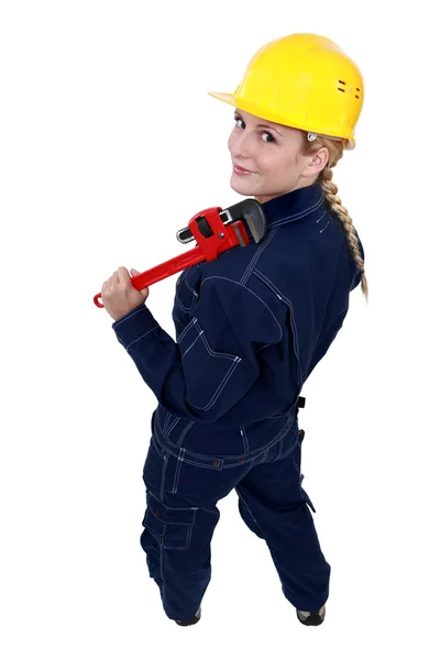 Tradeswoman holding a pipe wrench Royalty Free Stock Photos