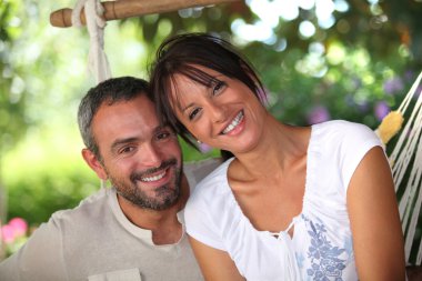 Couple sitting in hammock clipart