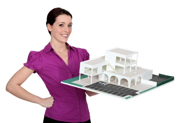 Woman holding a model of a building — Stock Photo, Image
