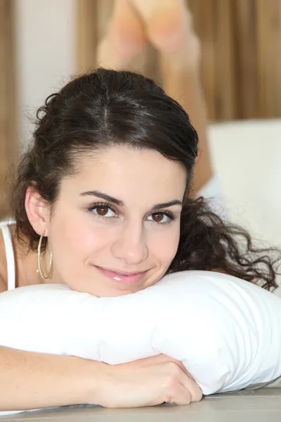 Pretty woman resting on a white pillow — Stock Photo, Image