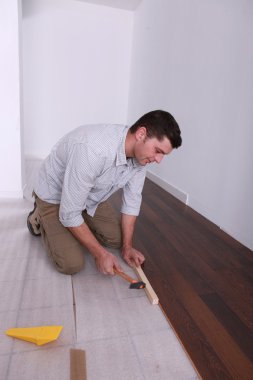 Handyman setting finish flooring clipart