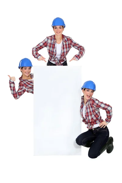 Montage of happy handywoman with white sign for message — Stock Photo, Image