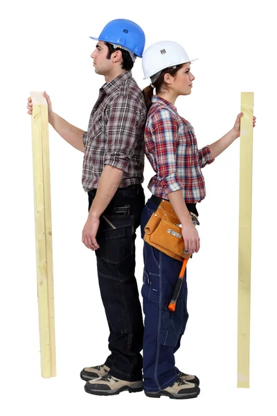 Carpinteiros masculinos e femininos de pé de costas para trás — Fotografia de Stock