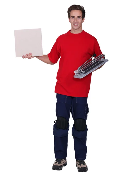 Portrét mladé dodávku člověka drží desky — Stock fotografie