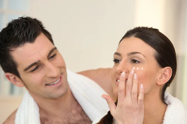 Woman applying moisturizing cream Royalty Free Stock Images