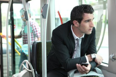 Man riding tram to work clipart