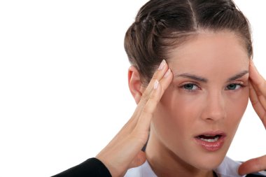 Angry woman having a headache clipart