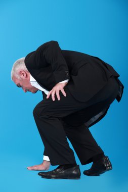 Businessman touching the floor clipart