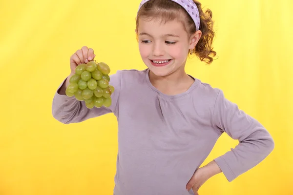 Little girl holding grapes — Stock Photo, Image
