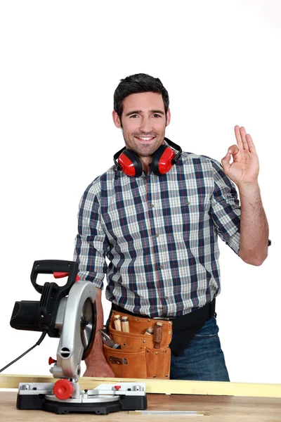 Man with circular saw making OK gesture — Stock Photo, Image