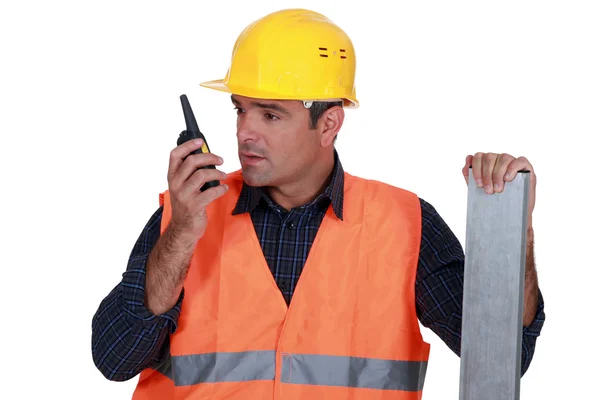 Craftsman talking on his walkie-talkie — Stock Photo, Image