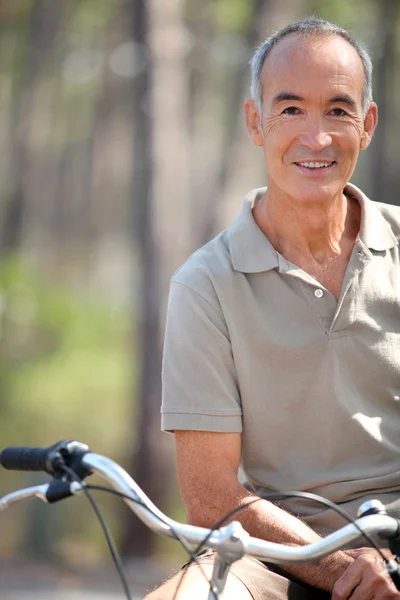 Middle-aged man riding bike — Stock Photo, Image