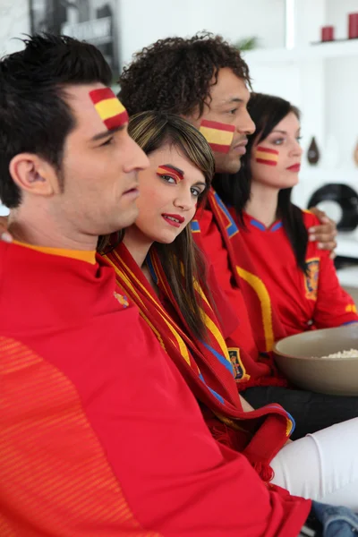 Portrait of Spanish supporters watching soccer match on telly — Stock Photo, Image