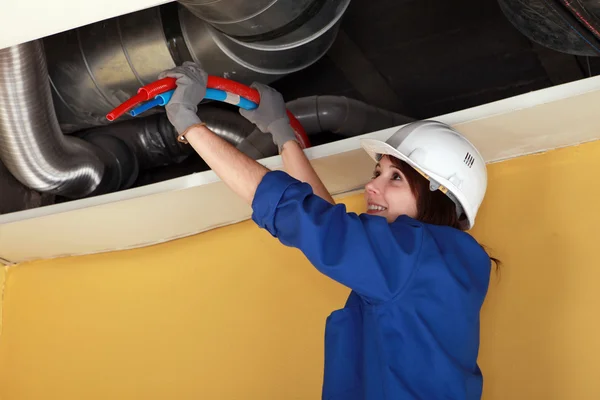 stock image Female plumber at work.