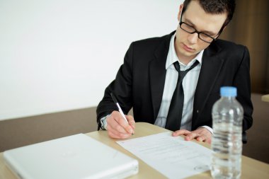 Young office worker doing paperwork clipart