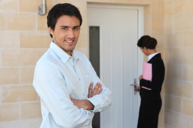 Estate agent showing man around property clipart