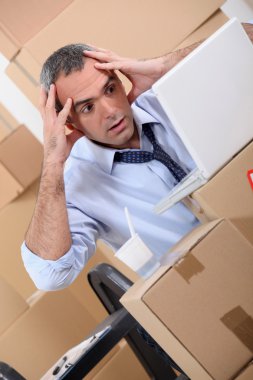 Man surrounded by boxes clipart