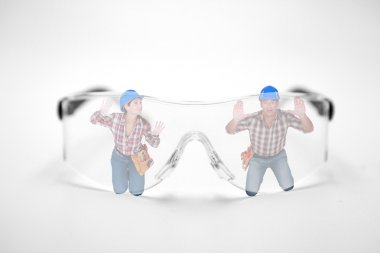 Man and woman stuck behind giant protective goggles clipart