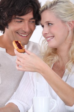 Couple eating biscuit's for breakfast clipart