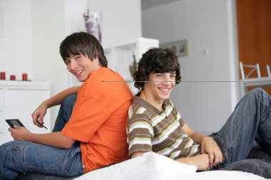 Two teenagers having fun at home clipart