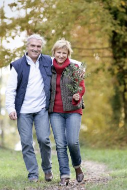 Couple taking leisurely walk clipart