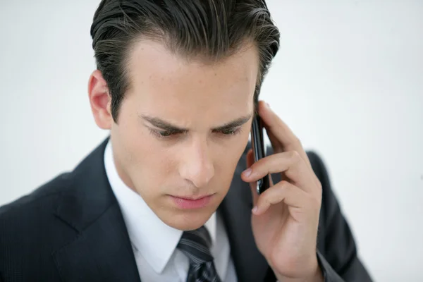 A concerned businessman talking on his mobile phone — Stock Photo, Image