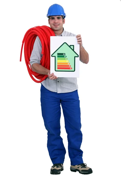 该名男子手持钢管和能源评级海报的长度 — 图库照片