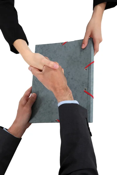 Two businesspeople shaking hands over document — Stock Photo, Image