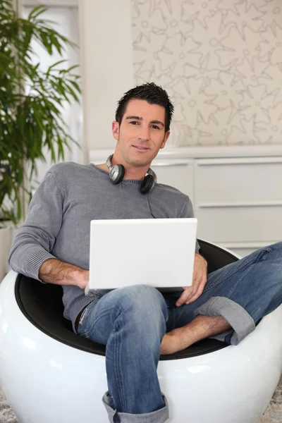Young man doing computer at home — Stock Photo, Image
