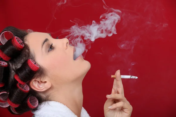Feminino fumante exalando sopros de fumaça — Fotografia de Stock