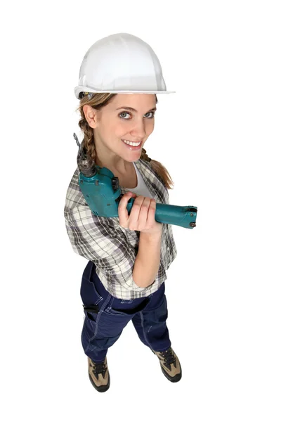 Eine Bauarbeiterin mit einer Bohrmaschine. — Stockfoto
