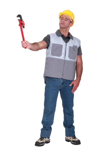 Man holding a pipe wrench — Stock Photo, Image