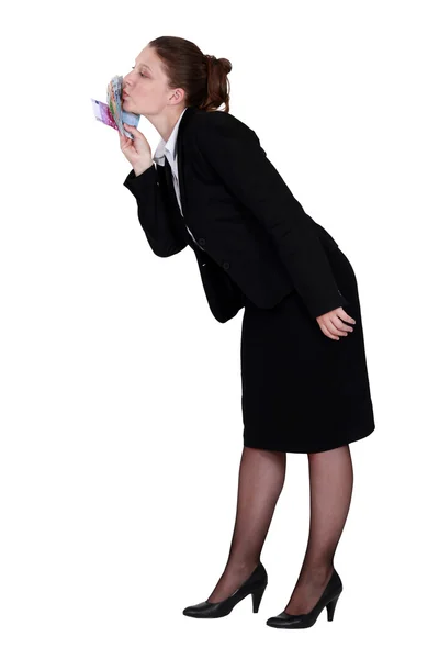 Businesswoman kissing money — Stock Photo, Image