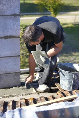 Mason with trowel and cement clipart