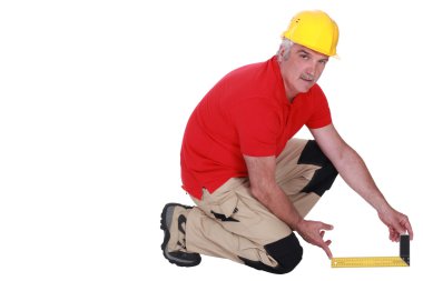 Tradesman holding a try square clipart