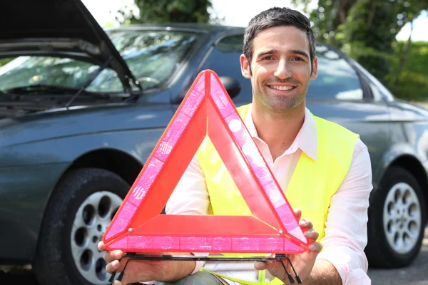 Portrait of a man with safety triangle — Stock Photo, Image