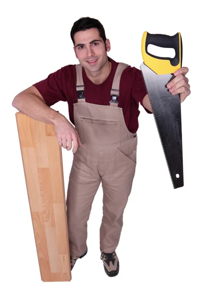 Craftsman with saw and wooden slat — Stock Photo, Image
