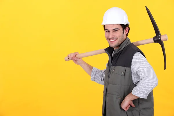 Cheerful man with a pickaxe — Stock Photo, Image