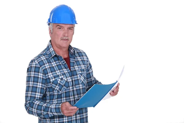 Foreman looking through paperwork — Stock Photo, Image
