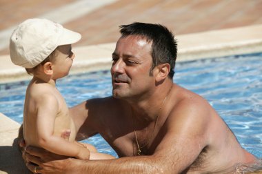 Father with his child in a swimming pool clipart